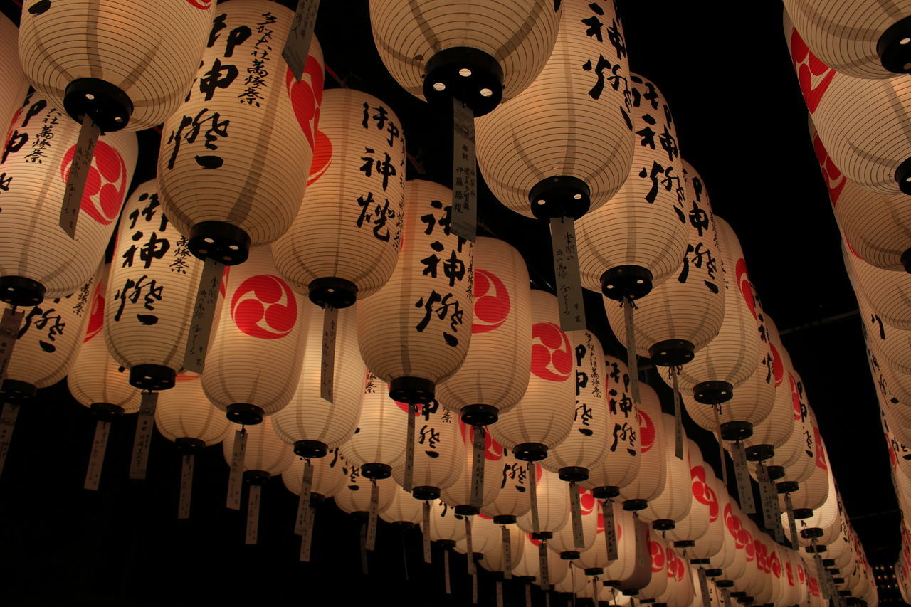 indoors, hanging, in a row, large group of objects, variation, still life, arrangement, order, choice, abundance, decoration, lighting equipment, multi colored, close-up, illuminated, low angle view, no people, art and craft, repetition, lantern