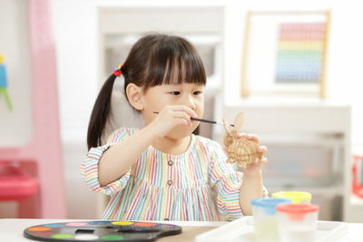 Young girl making craft for homeschooling