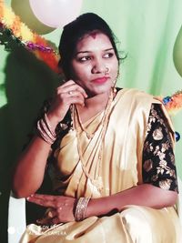 Close-up of young woman sitting on chair