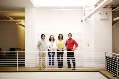 Portrait of business people standing in corridor