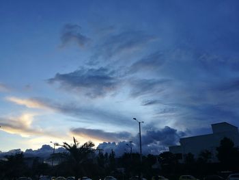 Low angle view of silhouette trees against sky