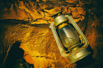 Low angle view of illuminated lighting equipment hanging on wall