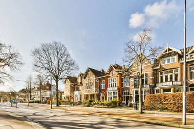 Street amidst trees against sky