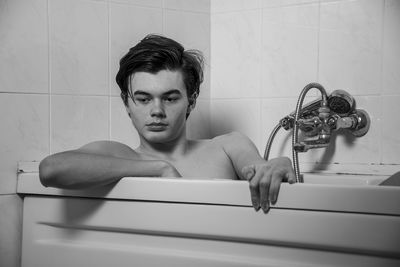 Portrait of young man in bathroom