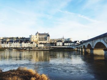 Bridge over river with buildings in background