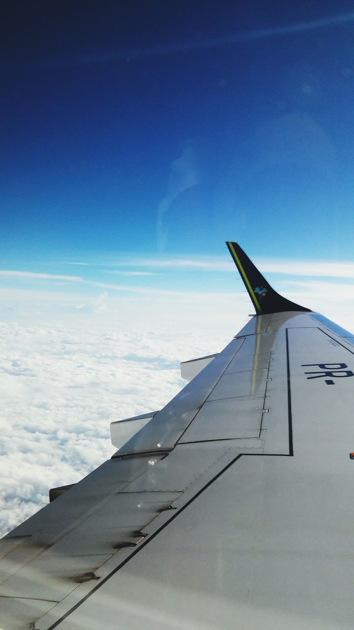 sky, low angle view, blue, cloud, cloud - sky, part of, cropped, sunlight, airplane, outdoors, day, no people, nature, flying, vapor trail, built structure, cloudy, beauty in nature, aircraft wing, white