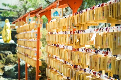 Close-up of clothes hanging in row for sale