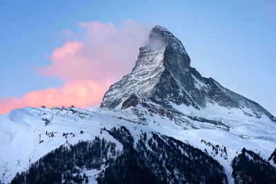 Scenic view of snow covered mountains against sky