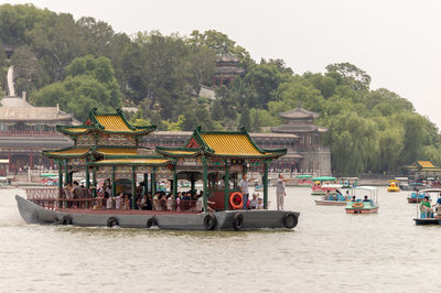 Group of people in boat against clear sky