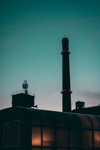 Silhouette industry against sky during sunset