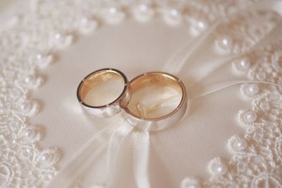 Close-up of wedding rings on cushion
