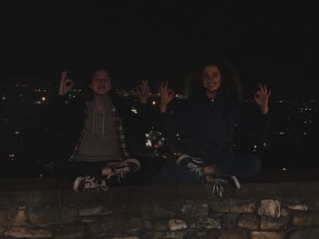 Portrait of a smiling woman sitting at night