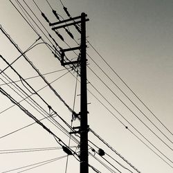 Low angle view of electricity pylon against sky