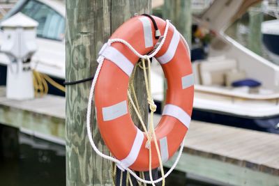 Close-up of red life ring hanging from boat