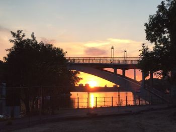 Bridge over river at sunset