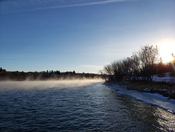 Scenic view of frozen lake against sky during winter