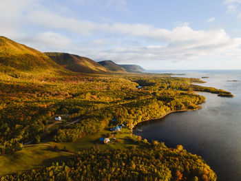 Scenic view of sea and mountains against sky in cape breton during autumn