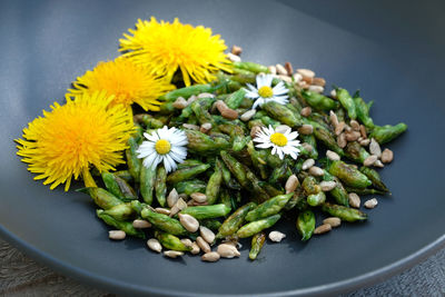 Close-up of yellow flowering plant on table