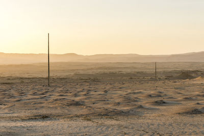 Scenic view of desert against sky during sunset