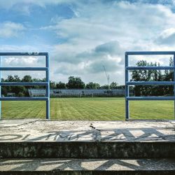 View of soccer field against cloudy sky