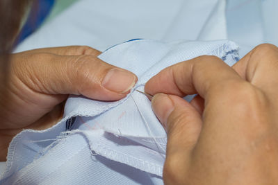 Midsection of tailor sewing textile