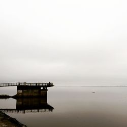 Pier over sea against sky