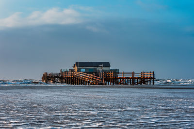 Pile dwelling on the beach of sankt peter-ording in germany.