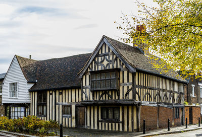 Exterior of house by building against sky