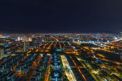 Aerial view of illuminated buildings in city at night