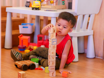 Boy playing with toy at home