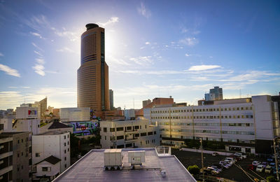 Buildings in city against cloudy sky