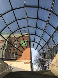 Low angle view of building seen through glass window