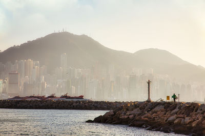 Panoramic view of sea and buildings against sky