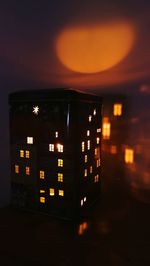 Illuminated building against sky at night