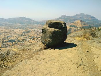 Rock on land against sky