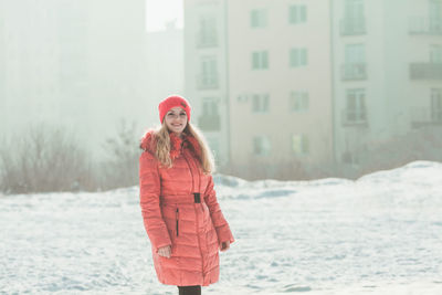 Portrait of woman standing in snow