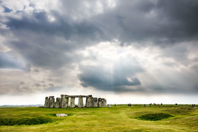 Built structure on field against sky