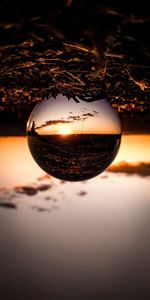 Close-up of crystal ball on beach