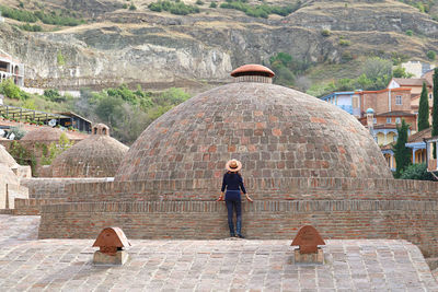 Female traveler exploring the medieval sulfur baths in old tbilisi, capital city of georgia