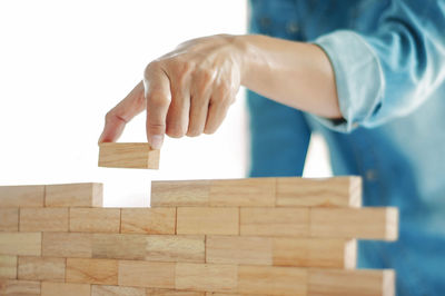 Midsection of woman stacking blocks