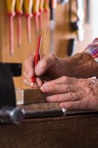 Midsection of carpenter working at workshop