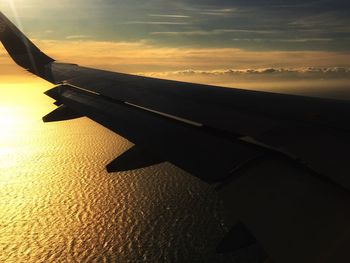 Cropped image of airplane at sunset