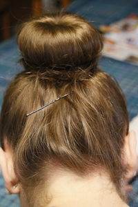 Close-up of woman with hair bun