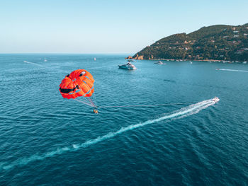 High angle view of people in sea against clear sky