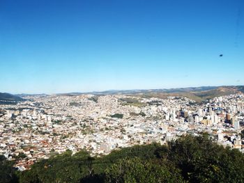 Aerial view of town against clear blue sky