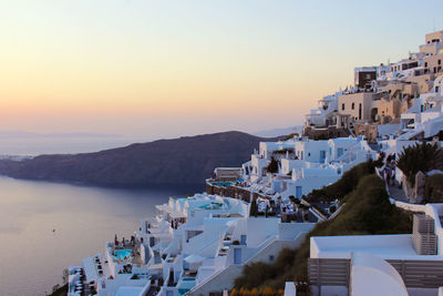 Panoramic view of town by sea against sky