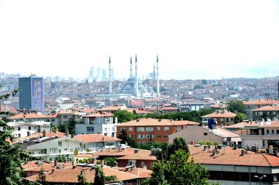 High angle view of houses in town against sky