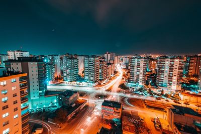 High angle view of illuminated city street and buildings at night