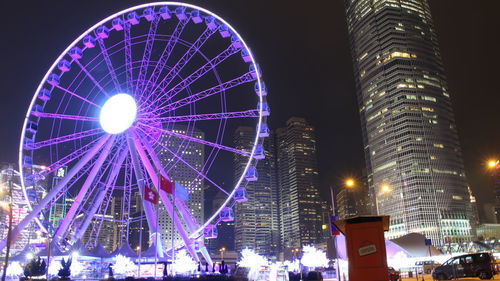 Low angle view of illuminated ferris wheel at night