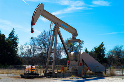 Low angle view of metallic structure against blue sky